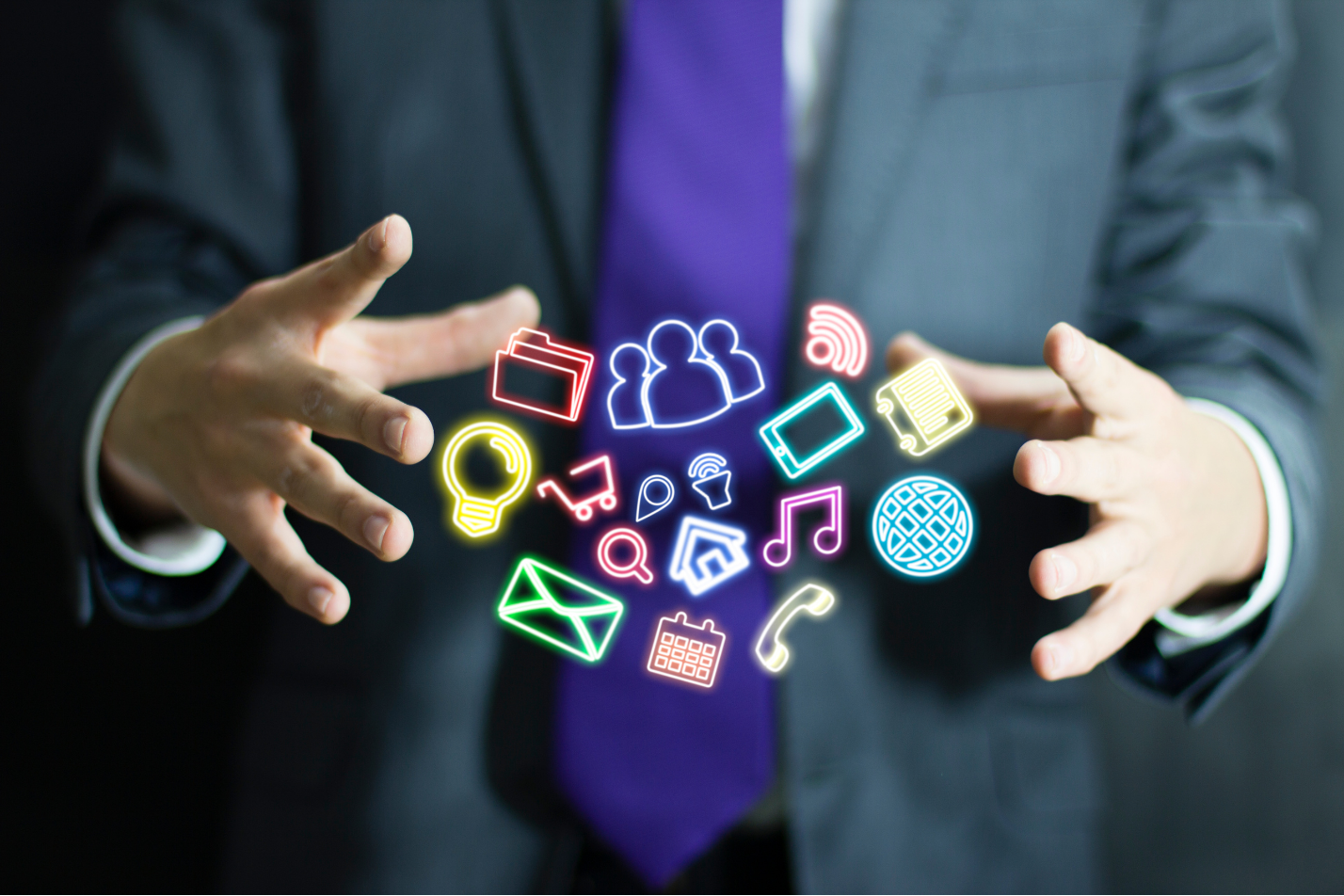 Business man holding mobile app icons