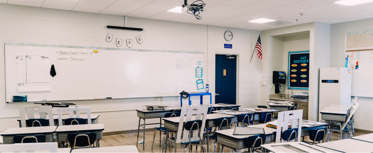 classroom with whiteboard, white walls and desks, 