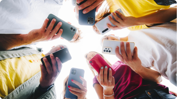 A group of people holding mobile phones