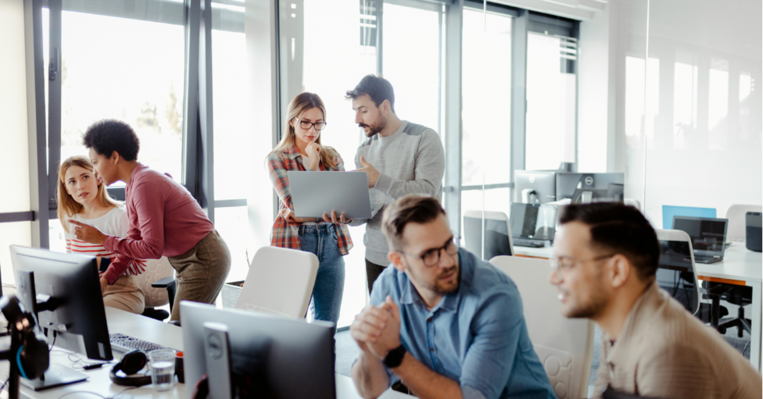 People at desktops in an office contact centre