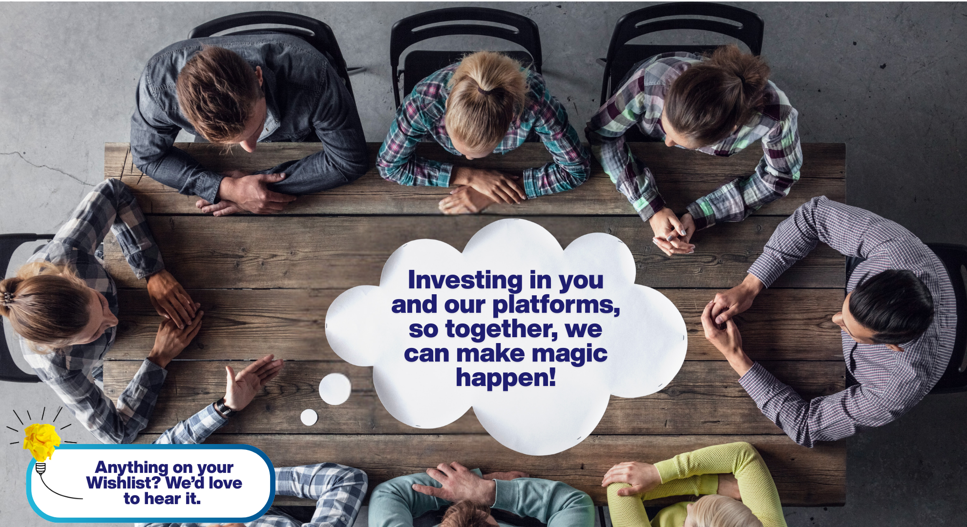 A top-down view of a collaborative team meeting around a wooden table, featuring a central thought bubble with the text: 'Investing in you and our platforms, so together, we can make magic happen!' A lightbulb icon in the corner asks: 'Anything on your Wishlist? We'd love to hear it.'