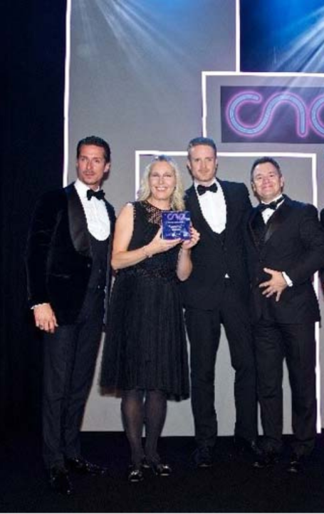 CNA Awards photo with 3 men and a women on stage accepting the award