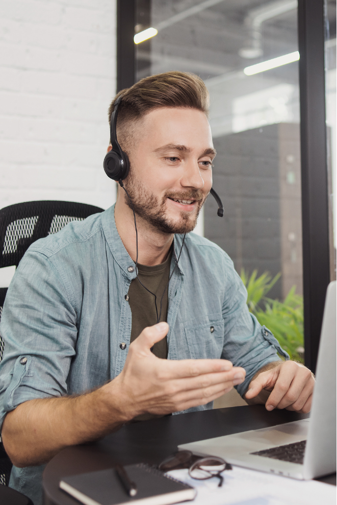 White man with a headset on working in an office