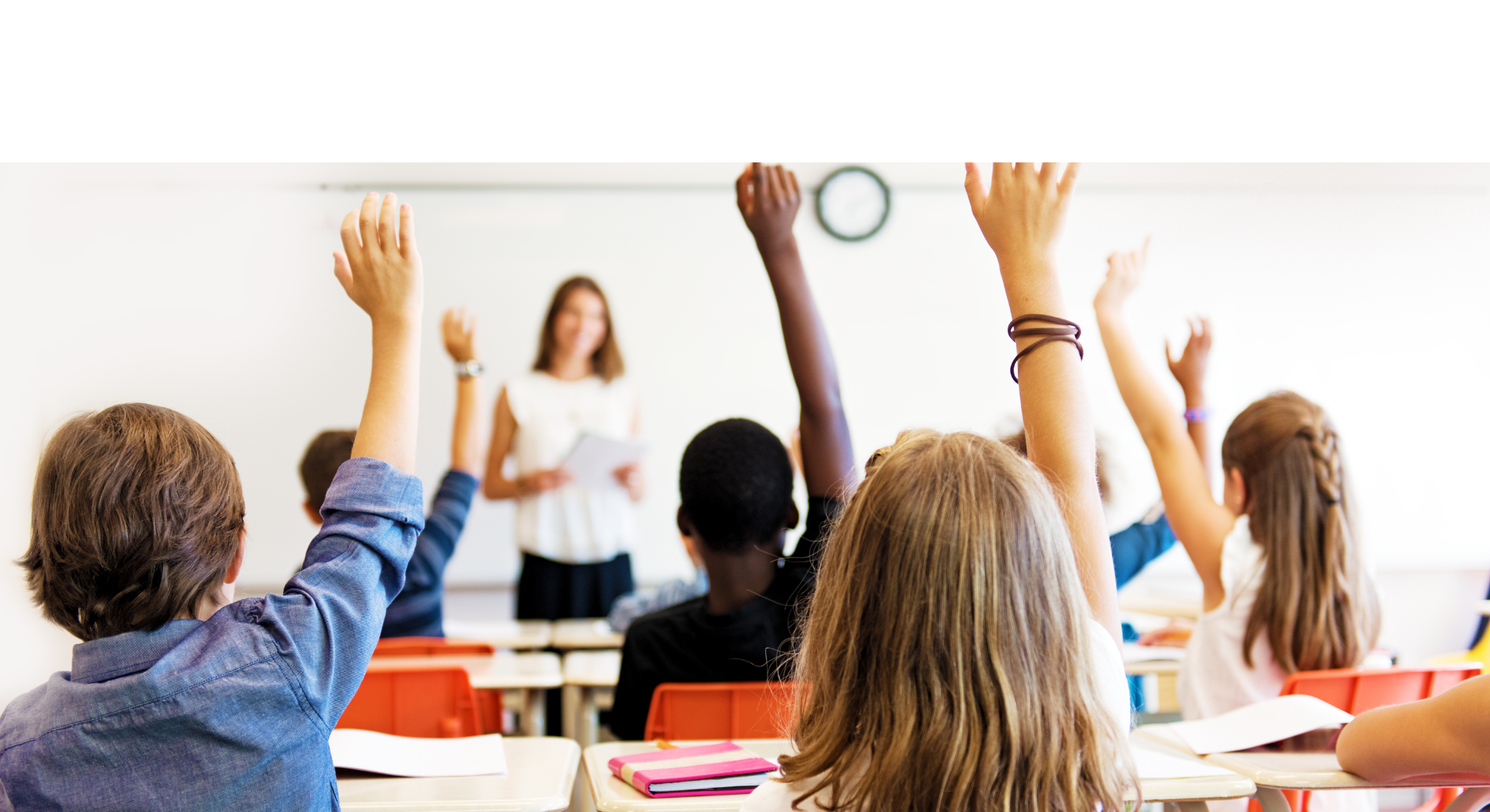 Kids putting their hands up in the classroom