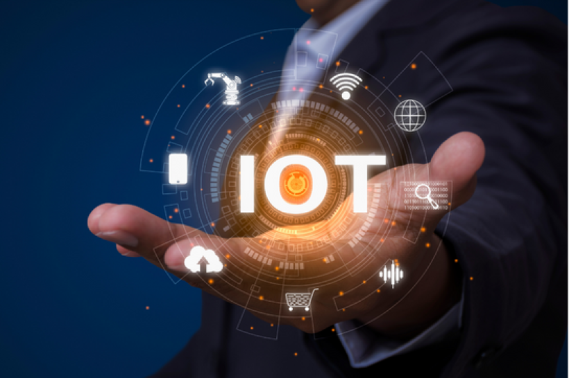 A hand with letters IoT above them